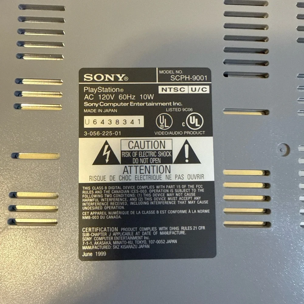 Sony Gray PlayStation Console with Two Wired Gray Controllers